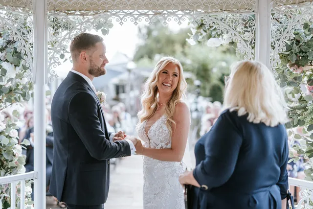 A couple holding hands during their vows