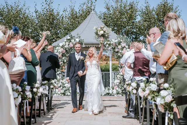 Confetti and cheers as a couple walk back down the aisle
