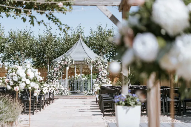 The gazebo seen through the ceremony florals