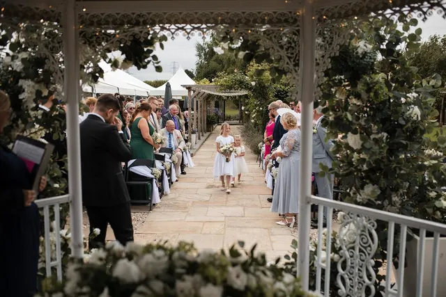 Guests watching a bride come down the lavender aisle