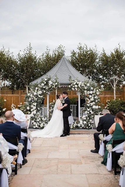 A couple exchanging rings at the gazebo
