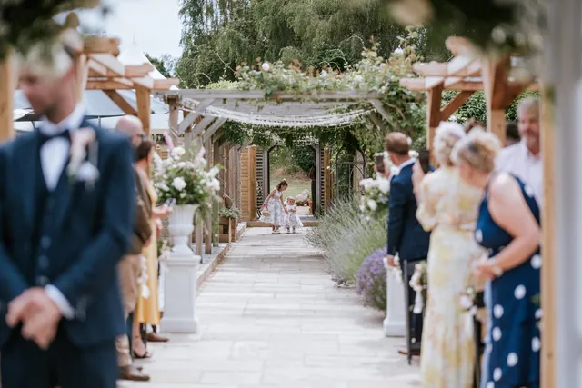 Guests lining the aisle as the bride arrives