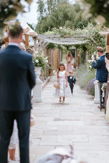 Children walking ahead of the bride down the aisle