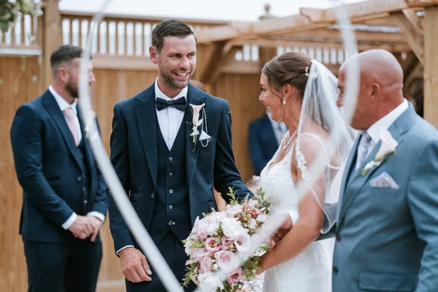 A newly married couple under the floral hoop