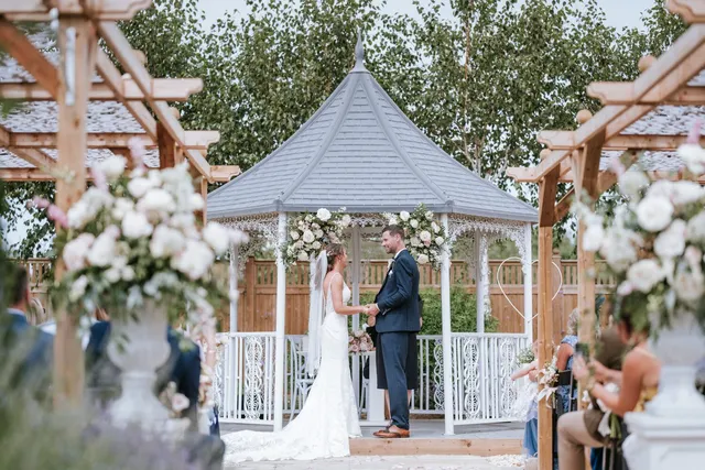 A ceremony at the white gazebo in the sunshine