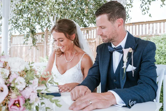 A couple signing the register together