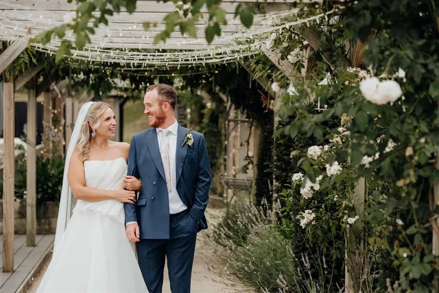 A couple walking back through the pergola