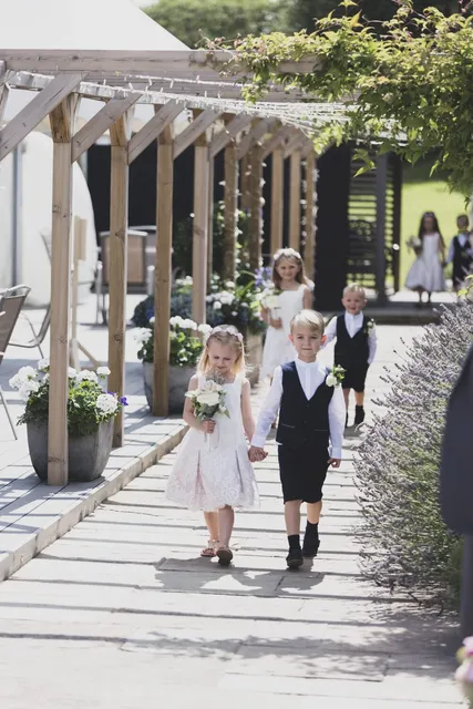Flower girls and a pageboy on the pergola walk
