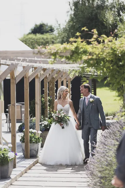 A couple walking hand in hand after the ceremony