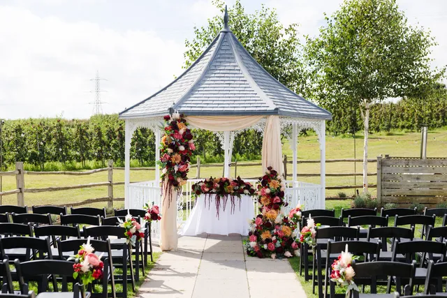 A rich autumn floral display dressing the Orchard Garden gazebo