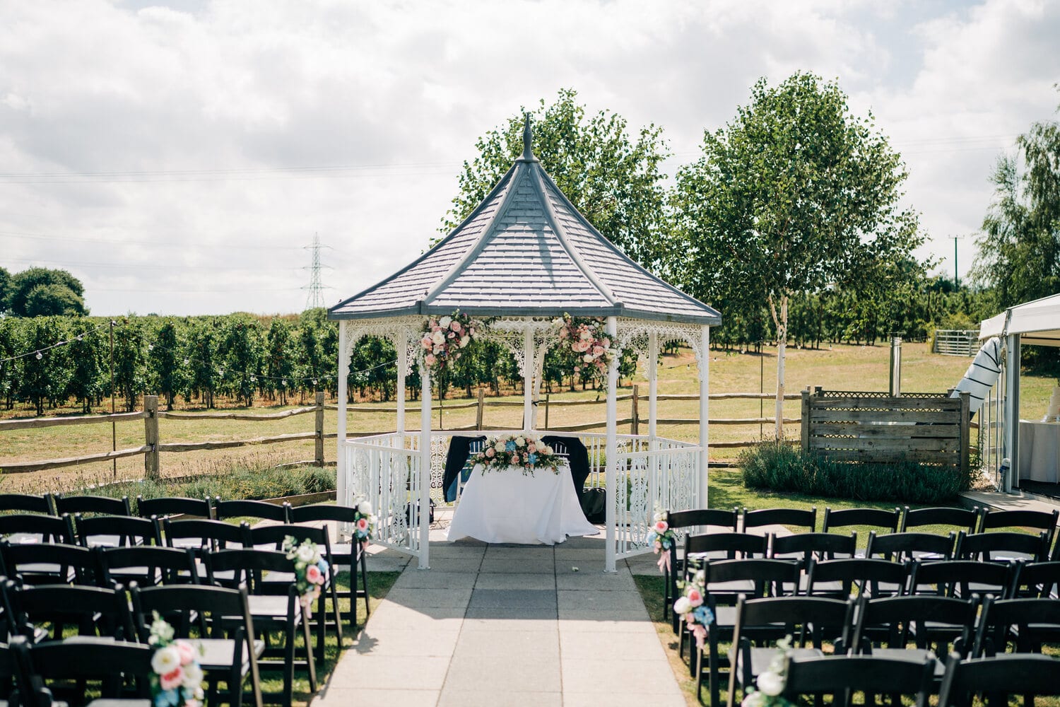 Chairs facing the gazebo set for an Orchard Garden ceremony