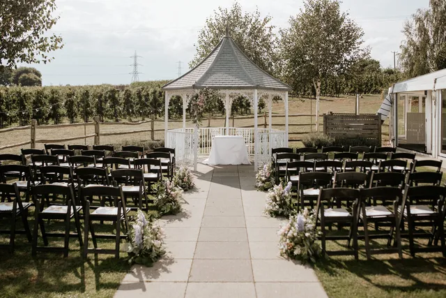 The Orchard Garden gazebo with a draped table, ready for a ceremony