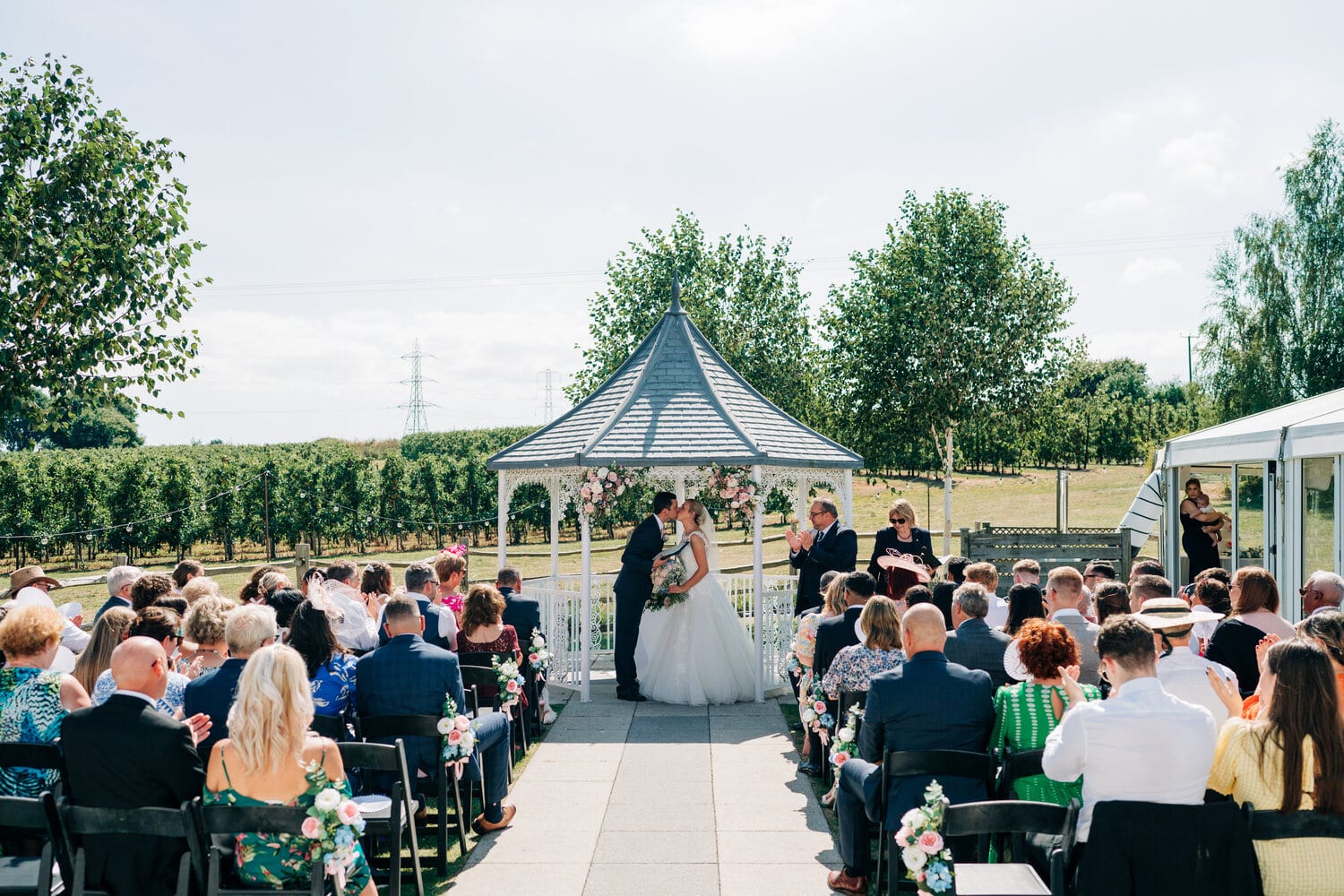 Guests seated for a ceremony at the Orchard Garden gazebo