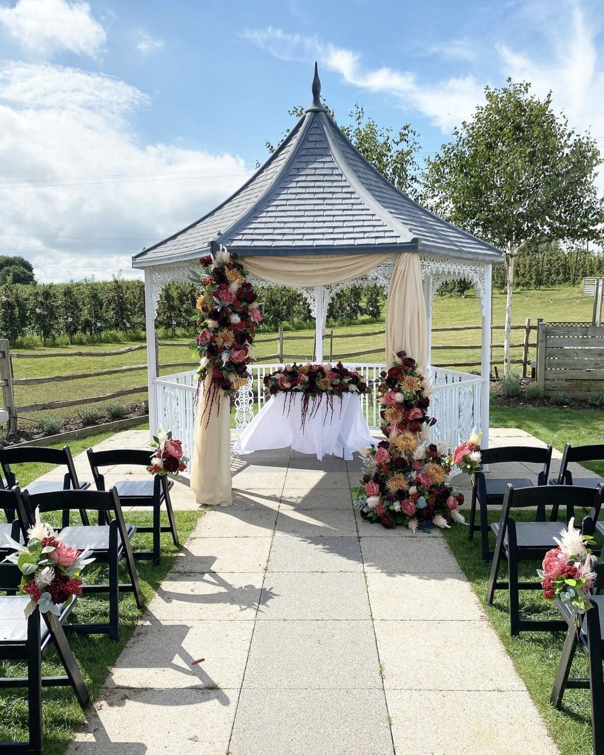 The Orchard Garden gazebo dressed with flowers for a ceremony