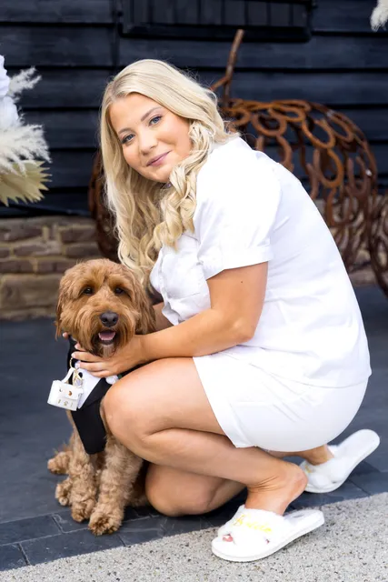 A bridesmaid with a cockapoo in a bow tie