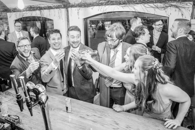 Wedding guests raising a toast at The BarnYard bar