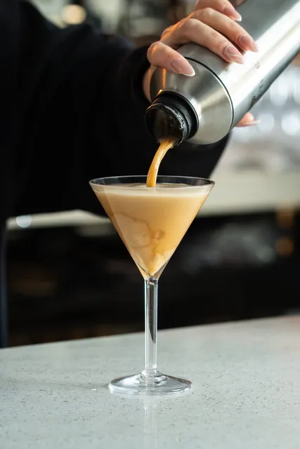 An espresso martini being poured at the bar
