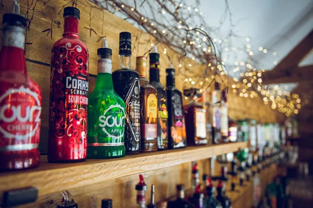The back bar at The BarnYard, bottles lit by fairy lights
