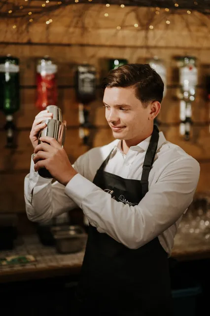 A BarnYard bartender shaking a cocktail
