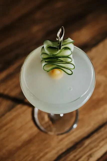 A gin cocktail dressed with a ribbon of cucumber