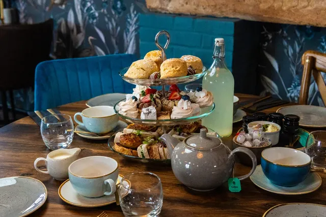 An afternoon tea stand with scones and sandwiches
