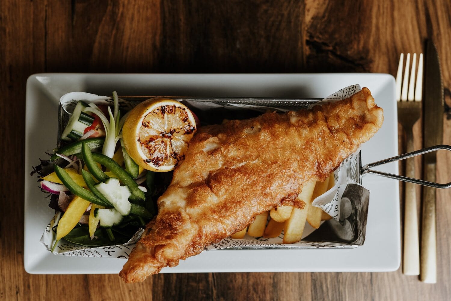 A plated fish dish with greens at The BarnYard