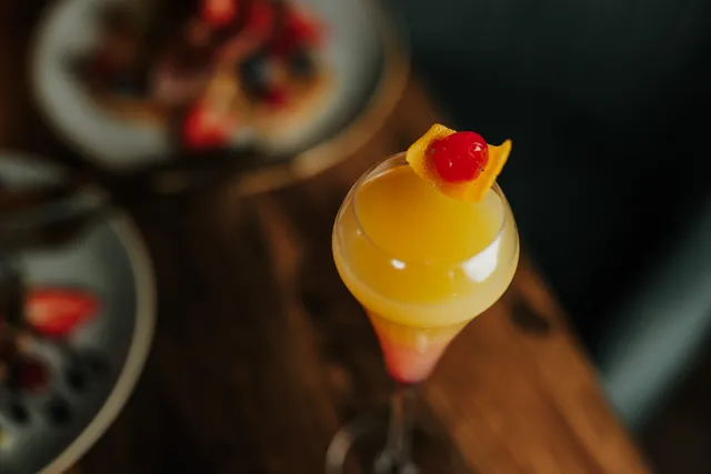 A fruit cocktail with a cherry garnish