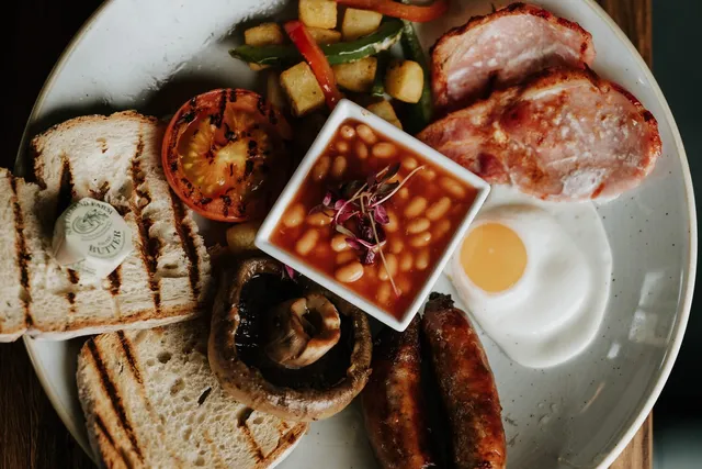 A breakfast board with beans, mushrooms and toast