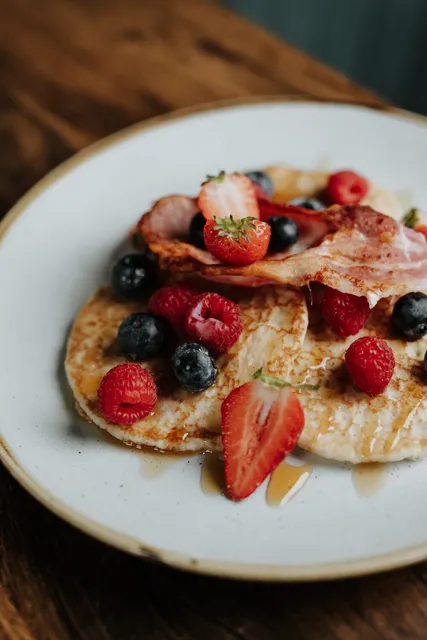 Pancakes with berries and bacon