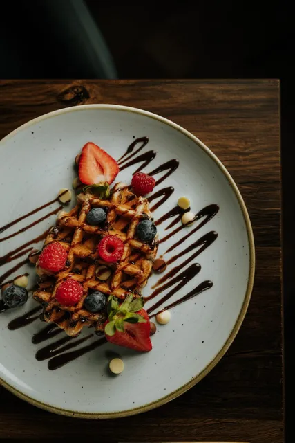 Waffles with berries and chocolate sauce