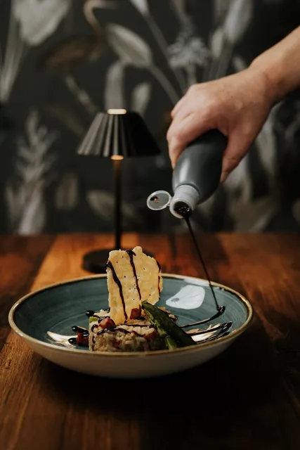 A dish being finished with a blowtorch