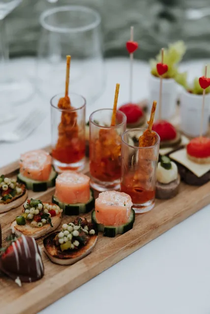 Canapes and chilled shots on a wooden board