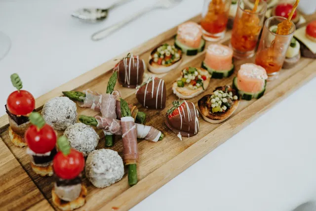 A long board of canapes ready for a reception