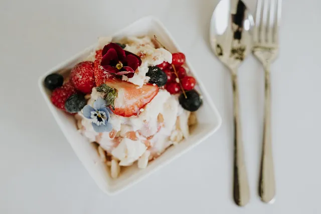 A berry dessert with edible flowers