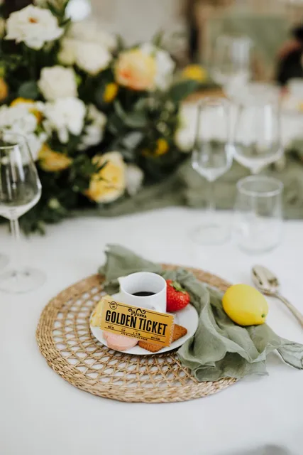A Golden Ticket place setting with a green napkin