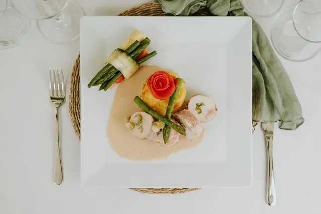 A chicken main with a tomato rose