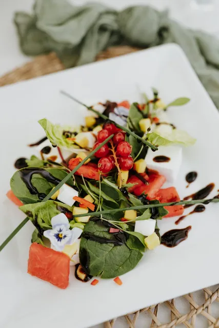 A watermelon and feta salad with edible flowers
