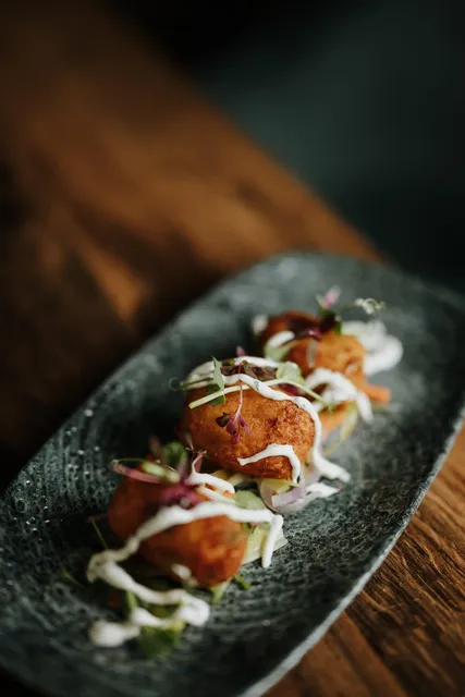 A fishcake starter on dark slate