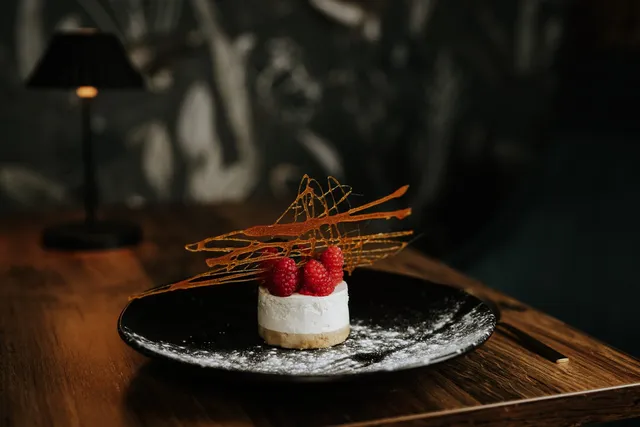 A raspberry cheesecake with spun sugar
