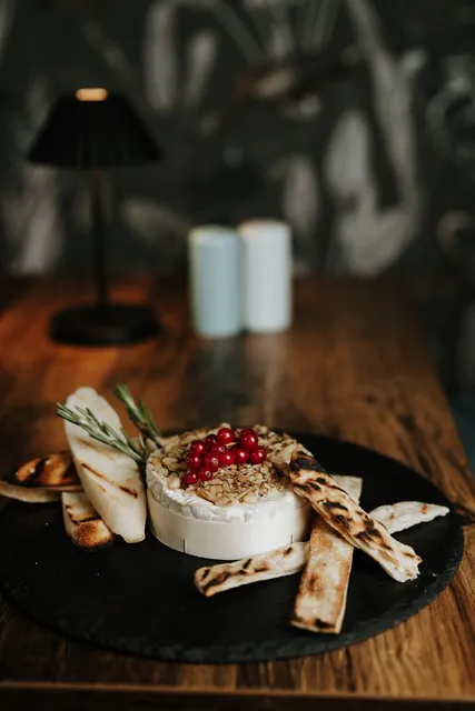 Baked camembert with redcurrants on slate