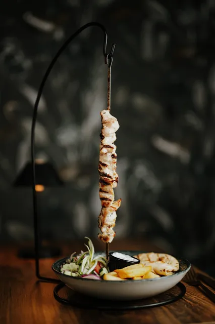 A hanging skewer served over a bowl