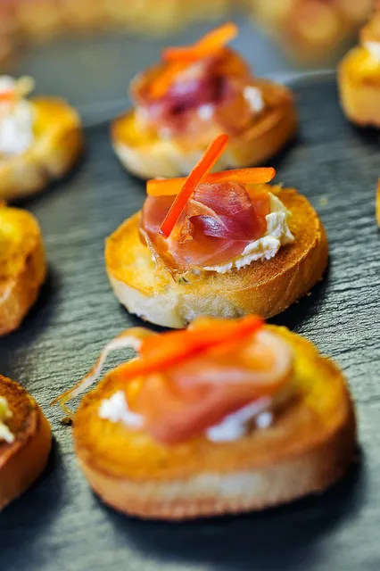 Canapes topped with salmon and prosciutto