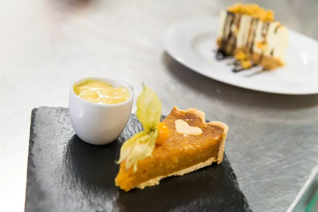 A tart with a pot of custard