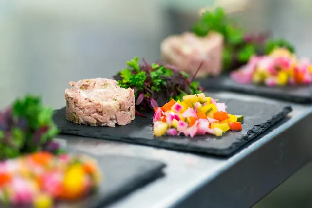 A pate starter with pickles on slate