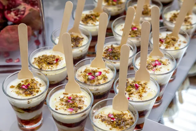 Dessert pots with wooden spoons ready for guests