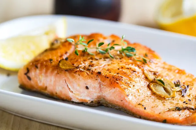 A baked salmon fillet with lemon and thyme
