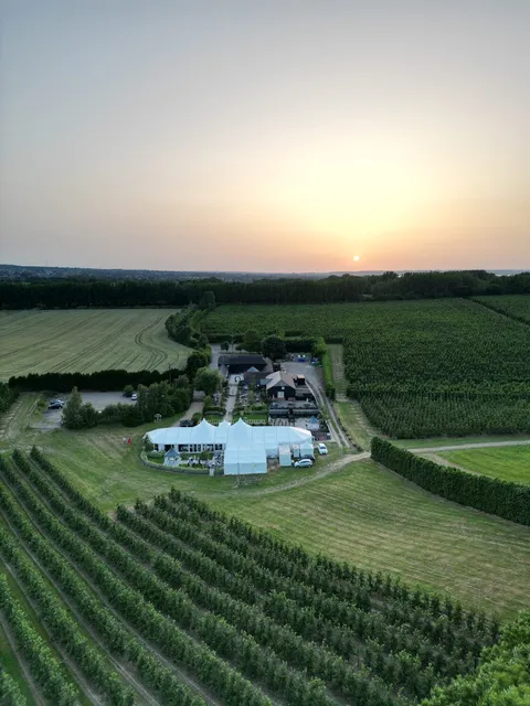 An aerial of The BarnYard at sunset among the orchards