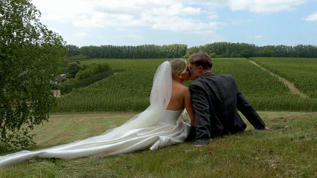 A couple lying in the grass with the veil spread out