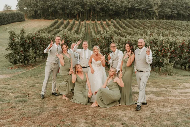 The full wedding party in the orchard