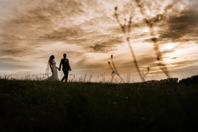 A couple walking the hill in sepia light